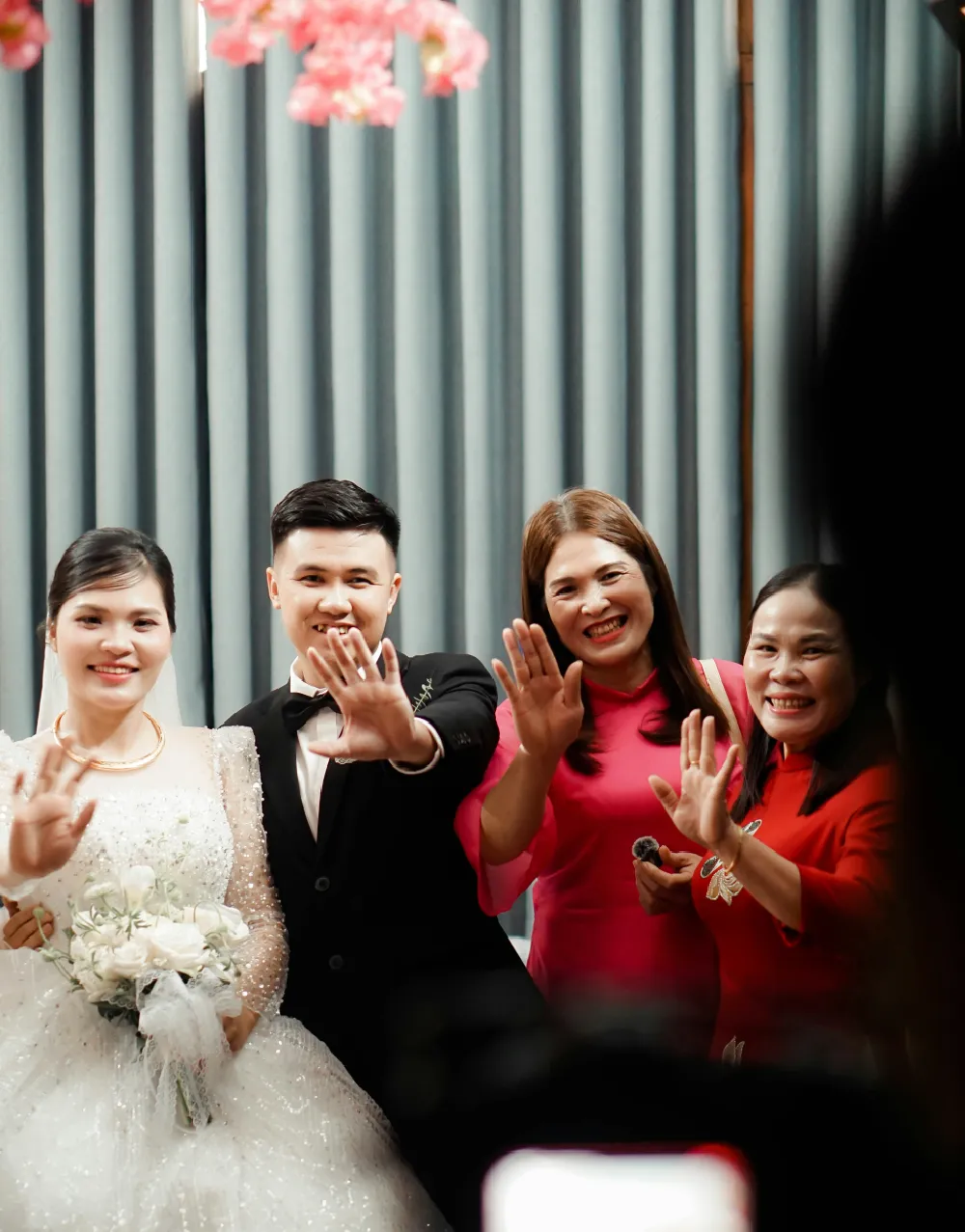 family posing in wedding photobooth